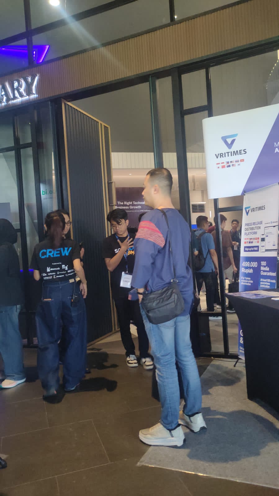 Networking at a tech conference entrance
